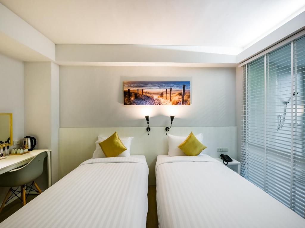 Kitzio House Hotel Huai Kwangにあるベッド