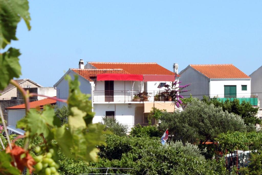 a white house with a red roof and some trees at Apartments by the sea Sucuraj, Hvar - 6732 in Sućuraj