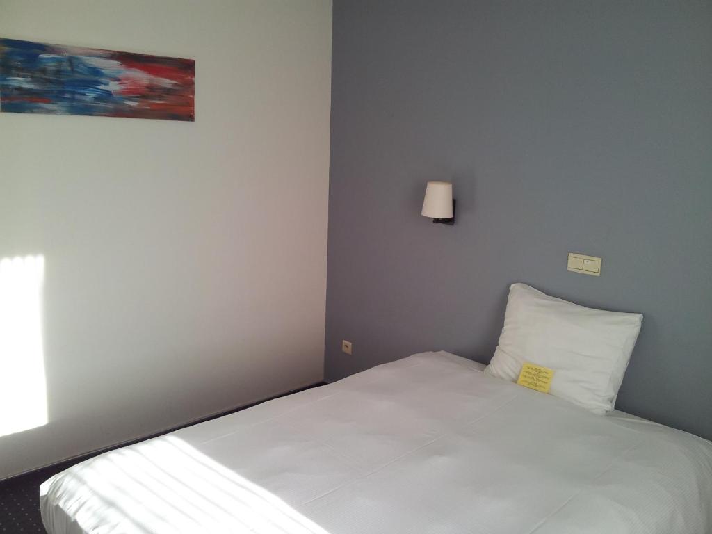 Postel nebo postele na pokoji v ubytování Hotel De Swaen
