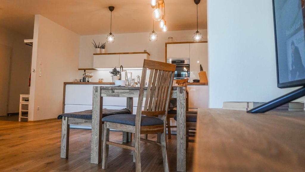 a dining room table with two chairs and a kitchen at Apartment Frida by Da Alois in Gröbming