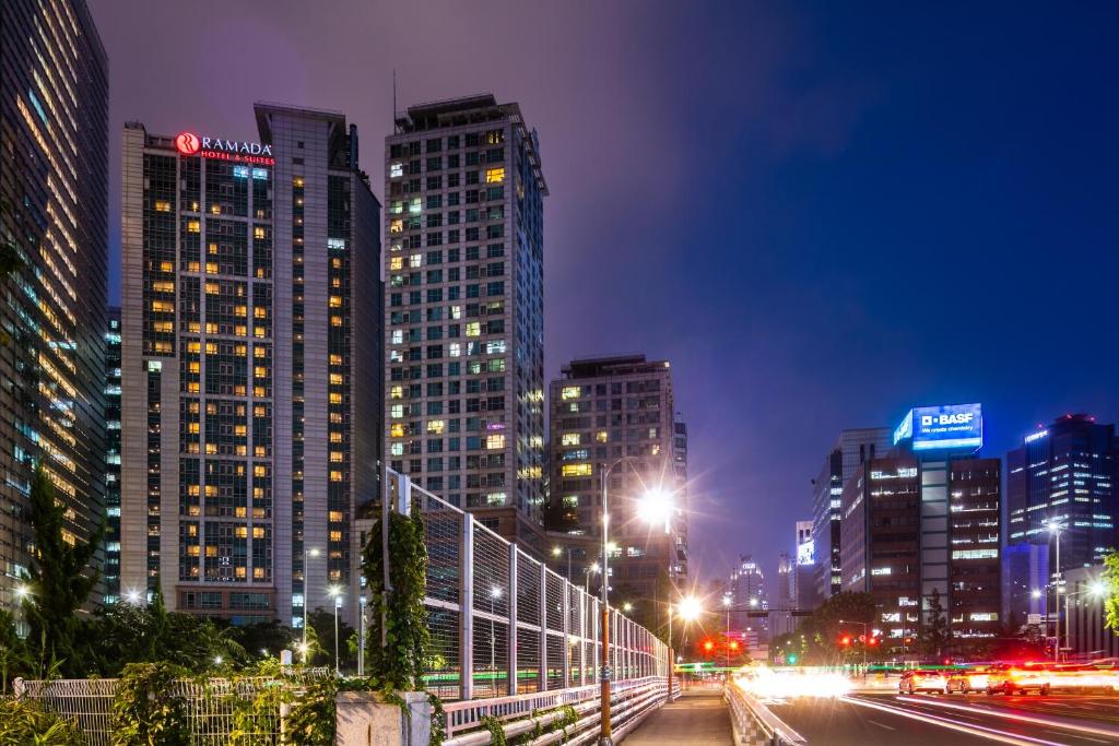 a city skyline with tall buildings at night at Ramada Hotel and Suites Seoul Namdaemun in Seoul