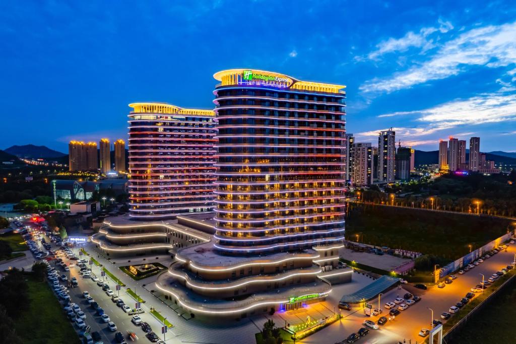 a rendering of a building in a city at night at Holiday Inn Express Huludao Seaview, an IHG Hotel in Huludao