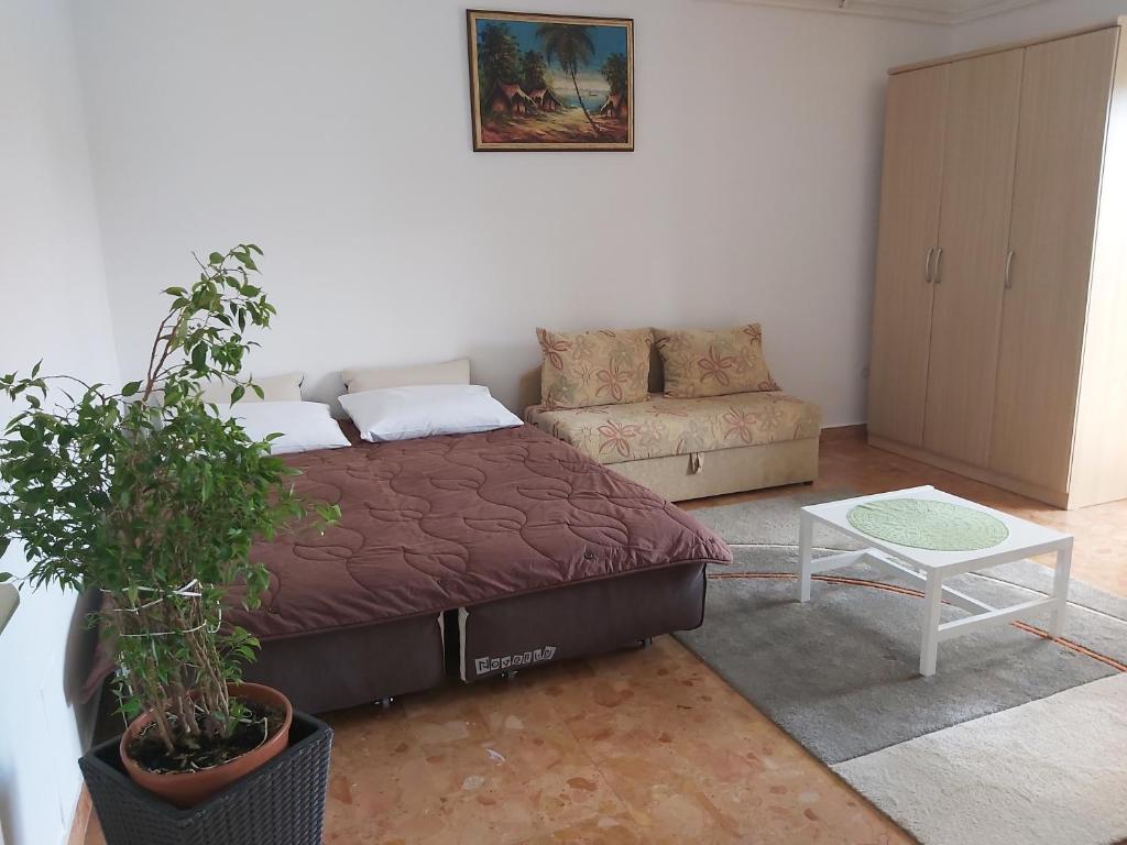 a bedroom with a bed and a couch at Apartments with a parking space Tar, Porec - 6943 in Tar