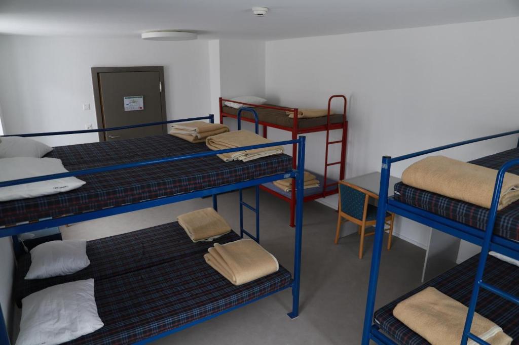 Postel nebo postele na pokoji v ubytování L'auberge de Noiraigue