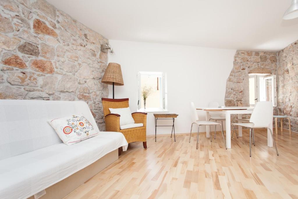 ein Wohnzimmer mit einem weißen Sofa und einem Tisch in der Unterkunft Apartments Rovinj Duplex in Rovinj