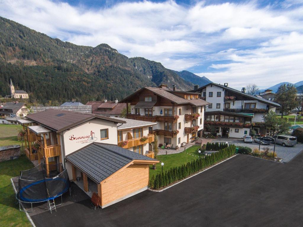 an aerial view of a town with houses and mountains at Hotel Brunnwirt in Weissbriach