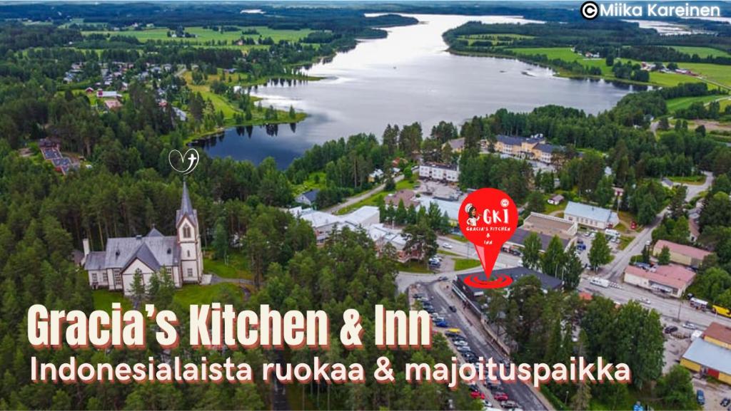 an aerial view of a town with a river and a church at Gracia's Kitchen & Inn in Valtimo