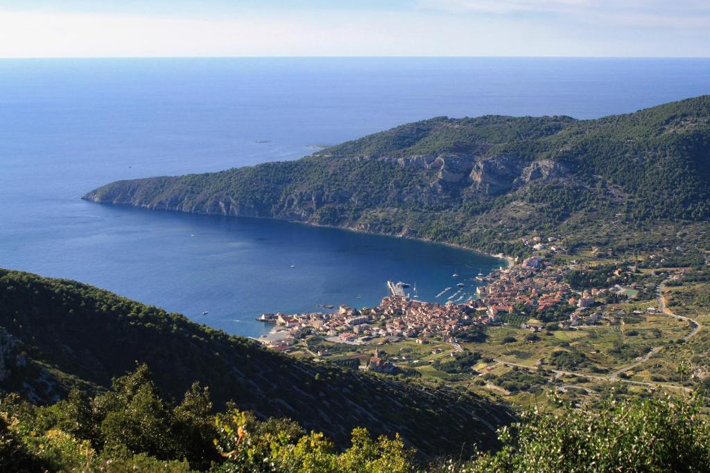 an aerial view of a town in the middle of a lake at Apartments and rooms by the sea Komiza, Vis - 2431 in Komiža