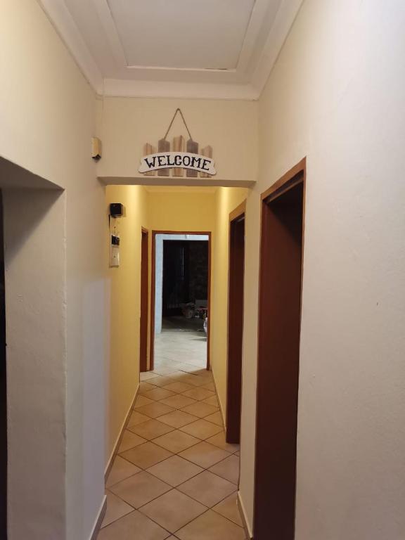 um corredor com um sinal de boas-vindas num edifício em LaMavuso Guesthouse em Krugersdorp