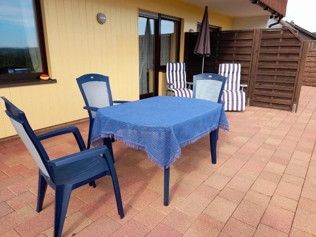 a blue table and chairs on a patio at Ferienwohnung Haus Weitblick in Medebach