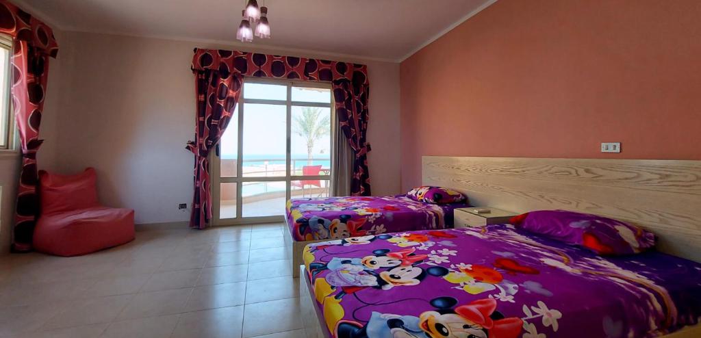 a bedroom with two twin beds and a window at Cheerful Villa - Romance Resort in Ain Sokhna