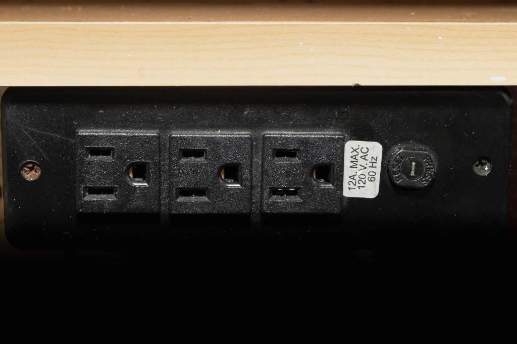 a black electrical outlet with a sticker on it at Red Roof Inn Myrtle Beach Hotel - Market Commons in Myrtle Beach