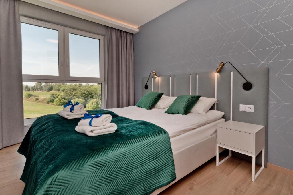 Postel nebo postele na pokoji v ubytování BlueApart Apartamenty Na Klifie