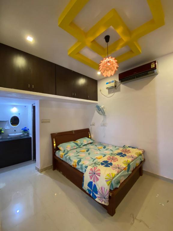 a bedroom with a bed and a ceiling at Rock N riveR in Malpe