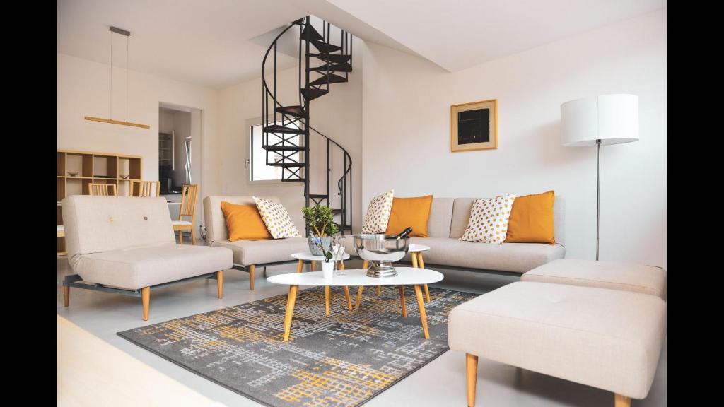 a living room with a couch and chairs and a table at One Only nassa Suite Apartment in Lugano