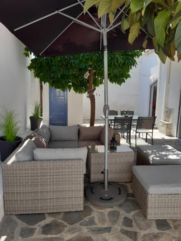 a living room with a couch and an umbrella at Dimitrios Loft Apartment in Volos