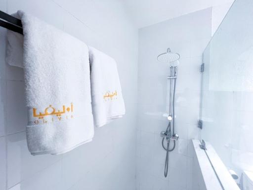 a bathroom with towels hanging on the wall at Olivia Chalet فلة أوليفيا in Al ‘Aqar