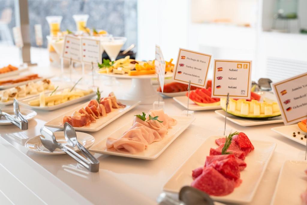 a buffet with many different types of food on plates at Royal Marina Suites Boutique Hotel - Adults Only in Puerto Calero