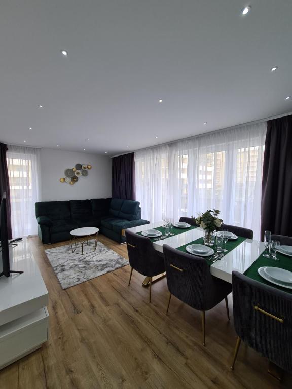a living room with a table and a couch at Luxury 2 bedroom holiday apartment in Braşov