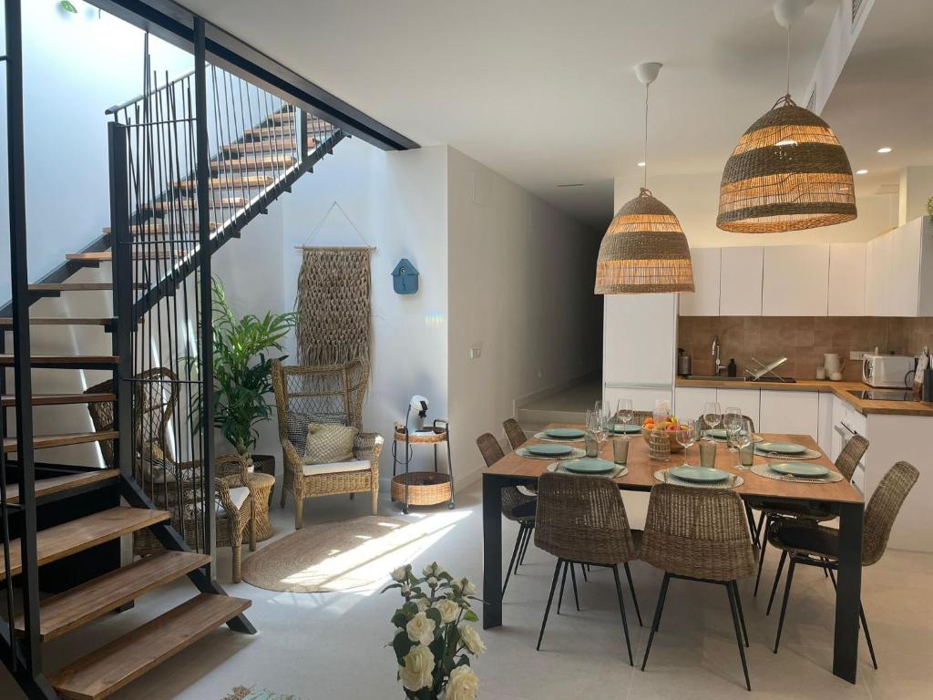 a kitchen and dining room with a table and chairs at AZUL PORTMÁN – DESIGNED FOR GROUP in Portman