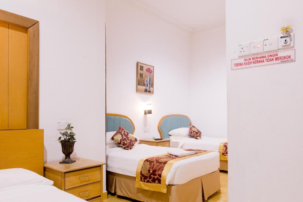 Ένα ή περισσότερα κρεβάτια σε δωμάτιο στο Villa Sri Mayang