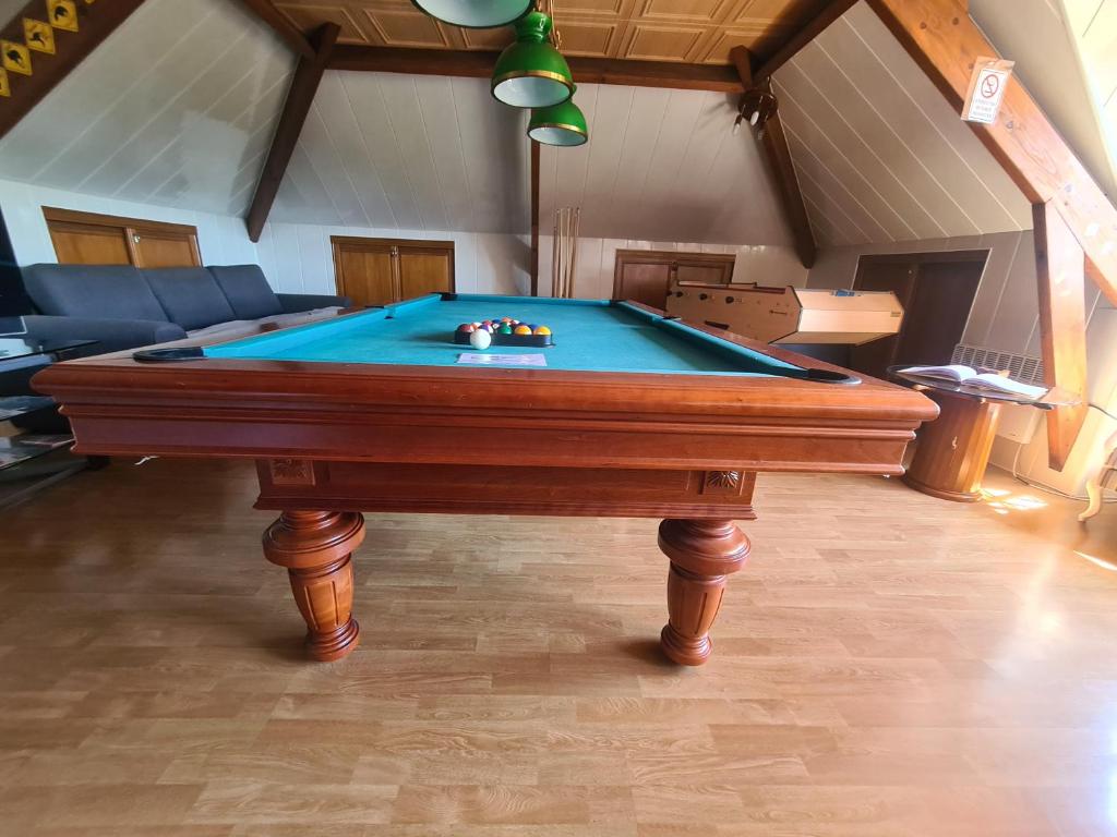 a pool table in the middle of a living room at LE GALOPIN Etaples le Touquet in Étaples