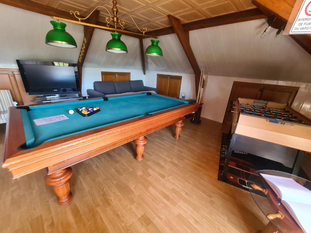 an overhead view of a pool table in a room at LE GALOPIN Etaples le Touquet in Étaples