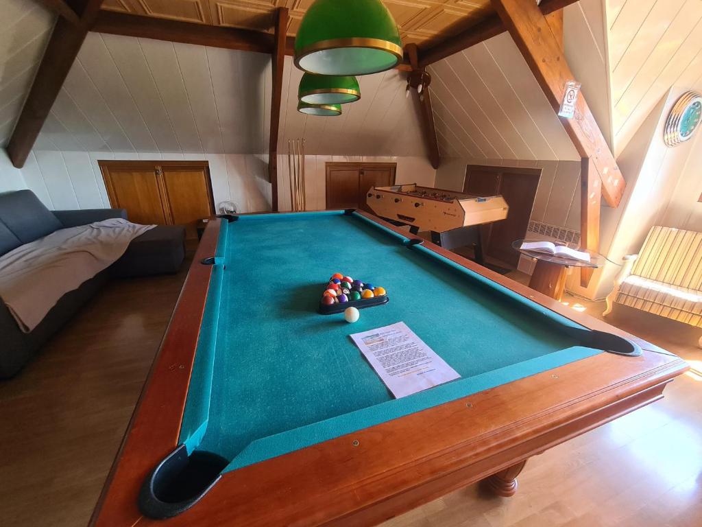a living room with a pool table in a room at LE GALOPIN Etaples le Touquet in Étaples