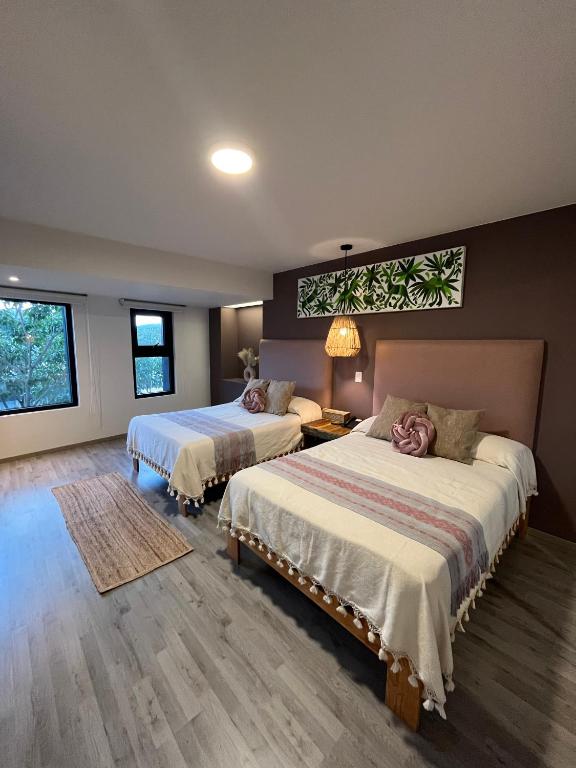 Postel nebo postele na pokoji v ubytování Zen Suites by Regente