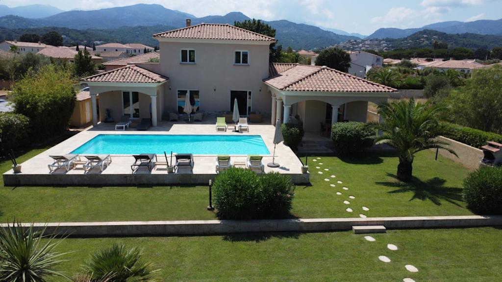 an external view of a house with a swimming pool at Villa Corse in Folelli