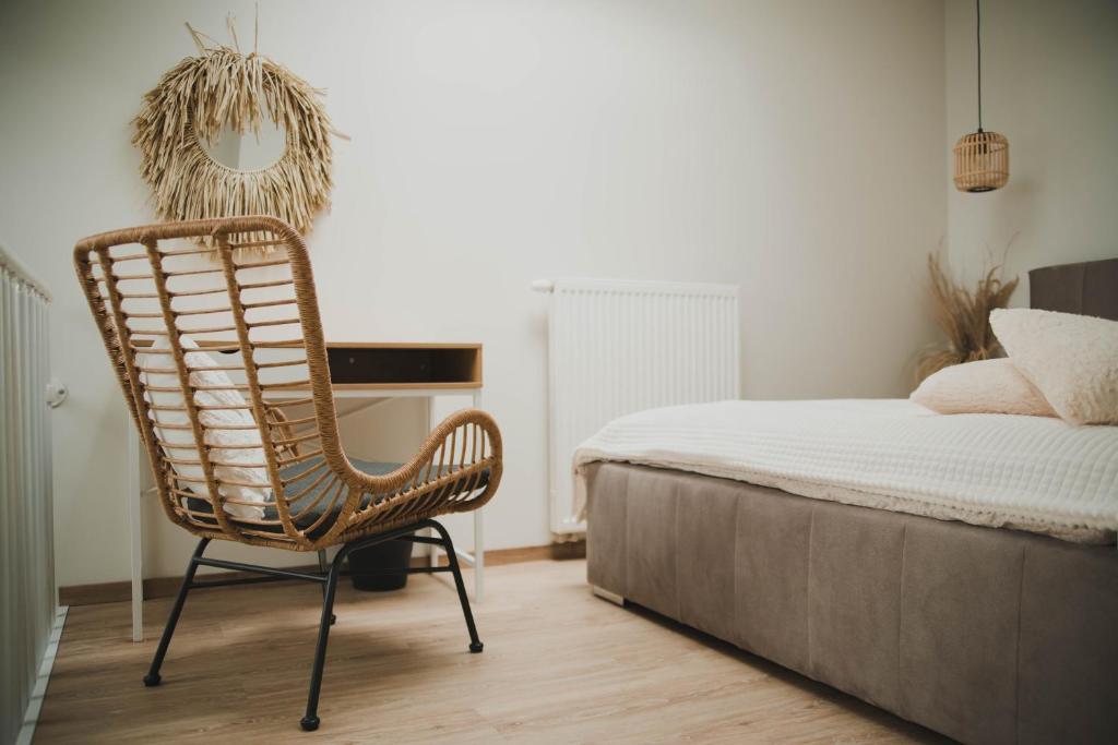 a bedroom with a chair next to a bed at Nadolnik apartment in Poznań