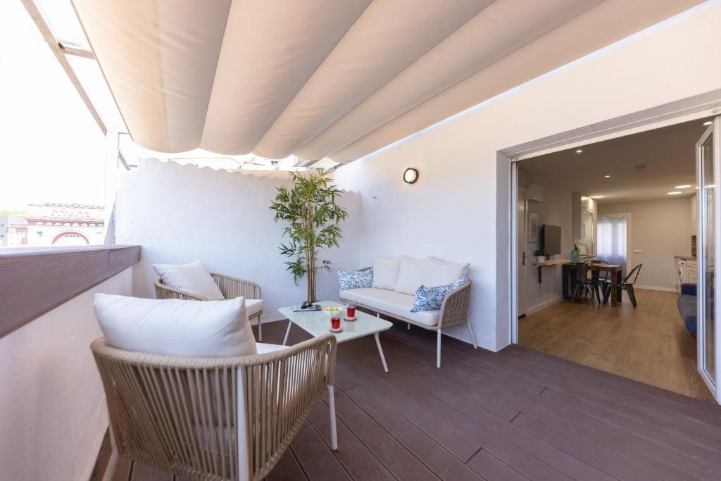 a living room with a couch and a table at Bravissimo Eiximenis, with beautiful terrace and views in Girona
