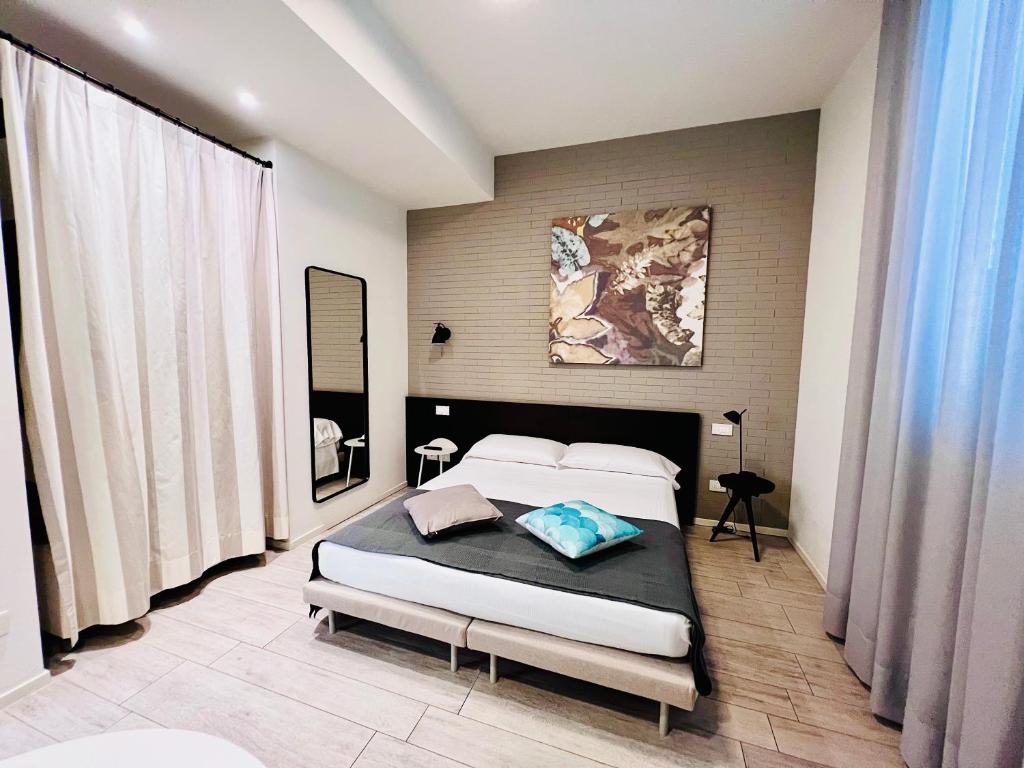 a bedroom with a bed and a painting on the wall at Le Stanze Guesthouse - di fianco alla Casa di Cura Montanari in Morciano di Romagna