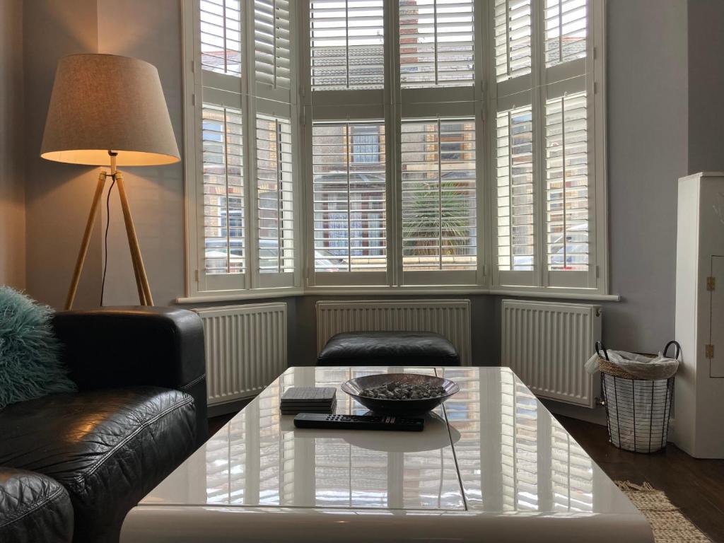 a living room with a couch and a coffee table at Tynwald Beachside Town House, West Kirby by Rework Accommodation in West Kirby