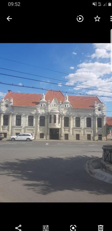 a building with a car parked in front of it at apartament Karla Indigo in Oradea