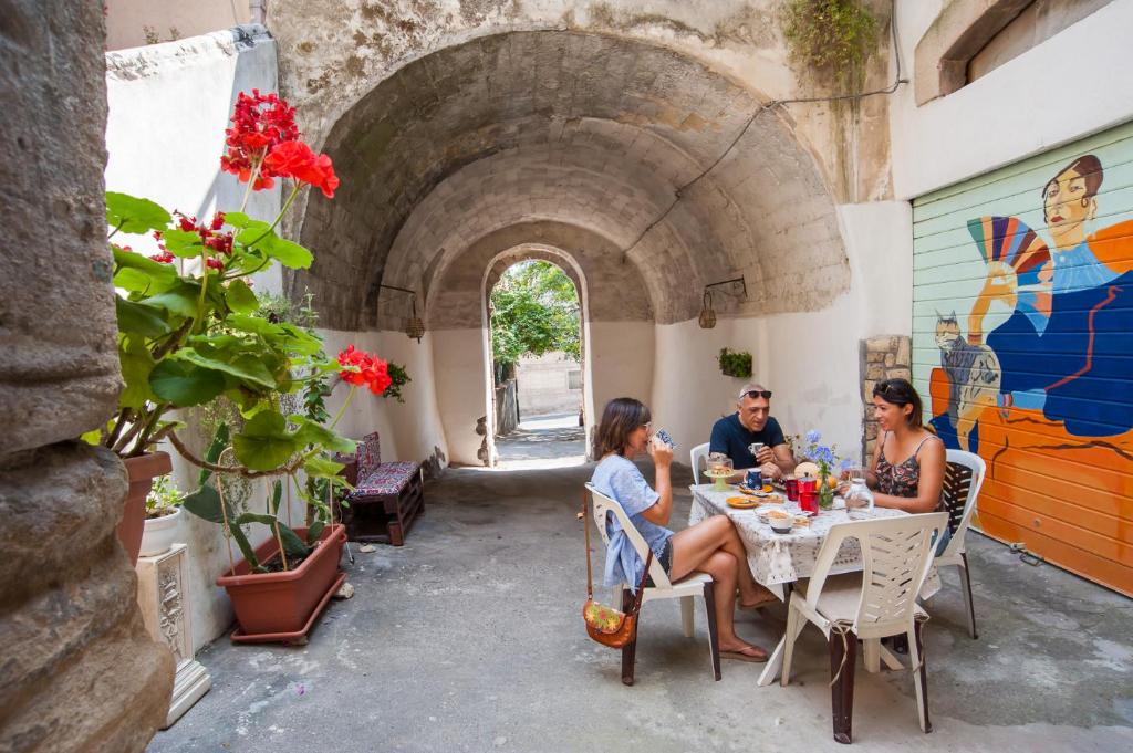 a group of people sitting at a table in a restaurant at Profumo di Zagara in Lentini