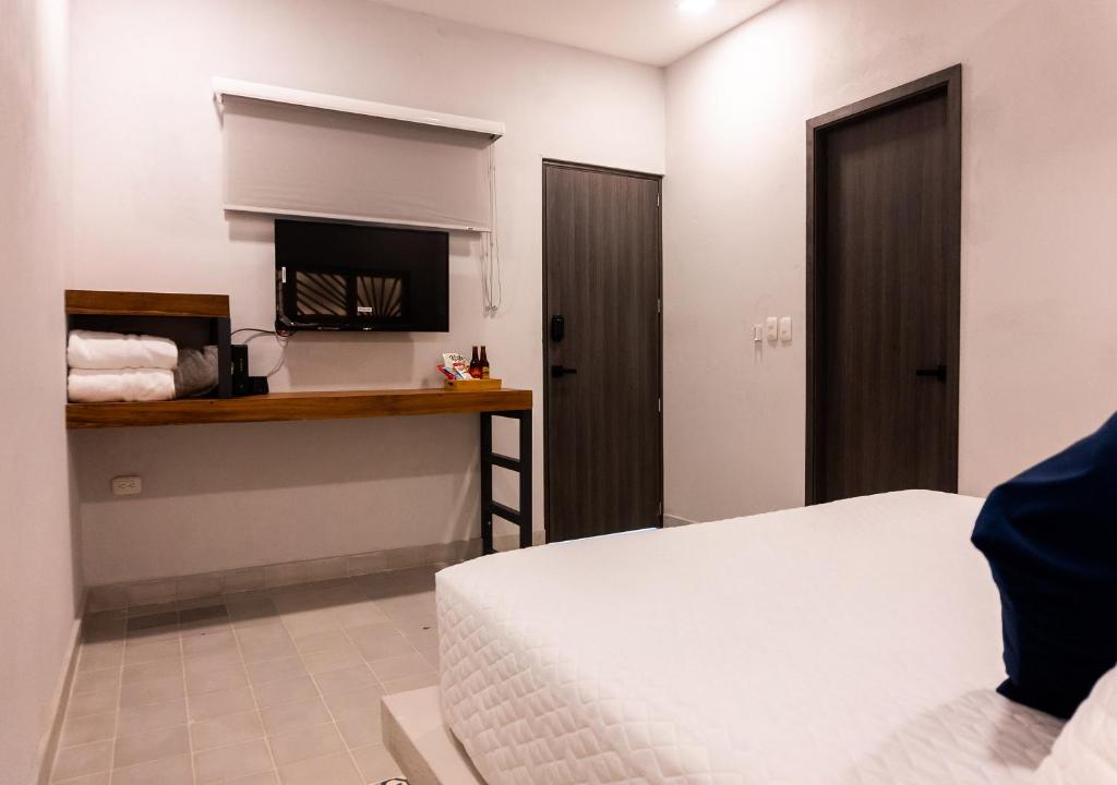 Postel nebo postele na pokoji v ubytování The Garden Suites