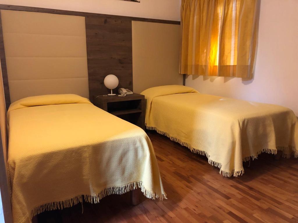 Postel nebo postele na pokoji v ubytování Hotel Miramonti