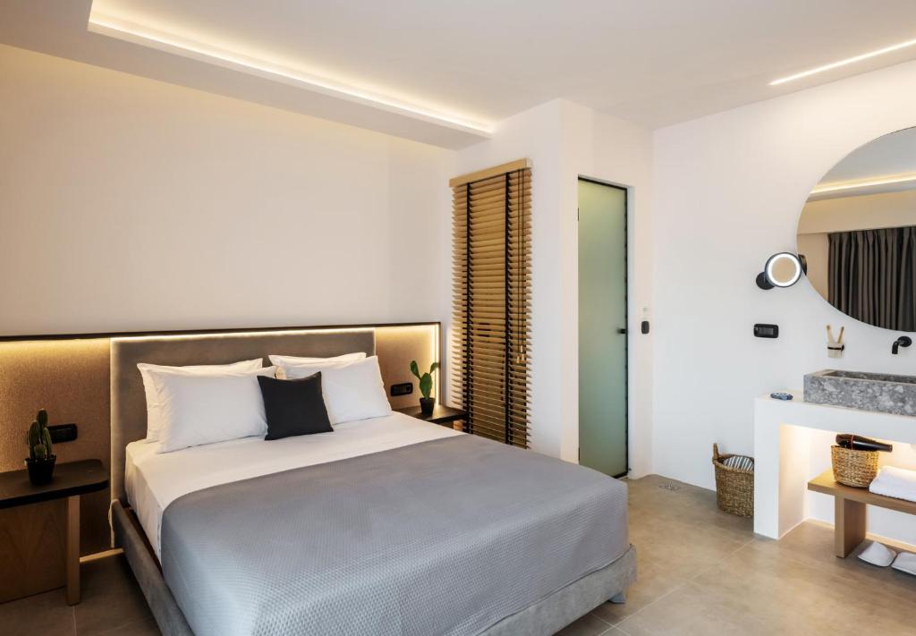 a bedroom with a large white bed in a room at Neapolis 21 Suites, Premium Key Collection in Skiathos Town