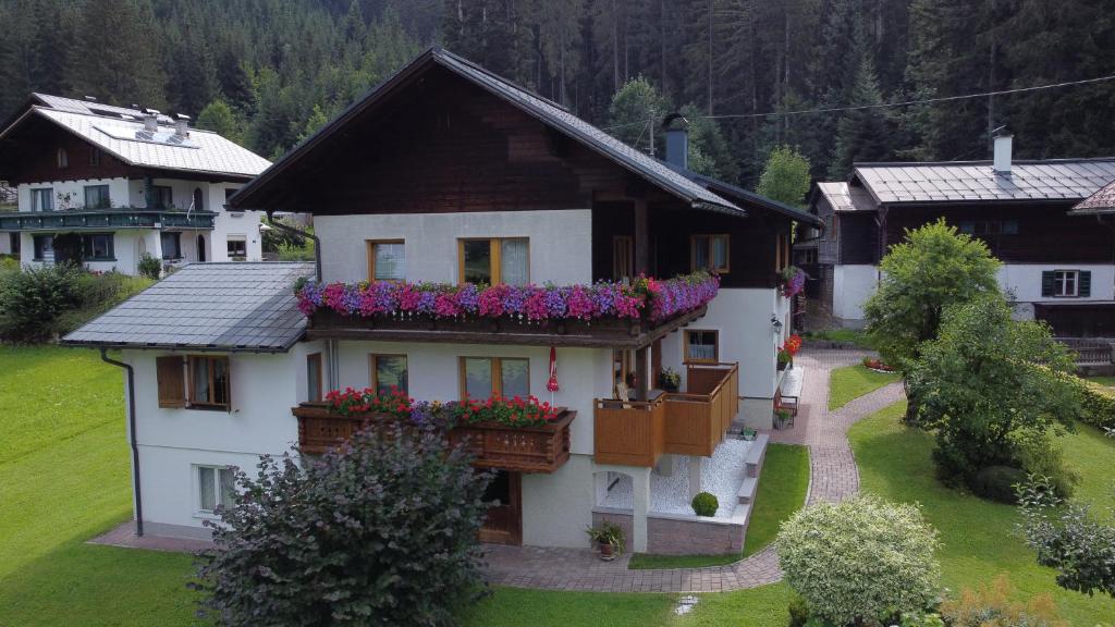 a house with flower boxes on the front of it at Andrea Schmaranzer - Privatzimmer in Gosau