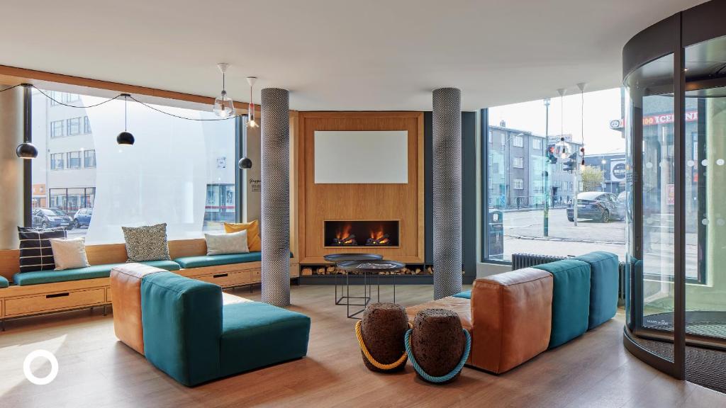 a living room with couches and a fireplace at Center Hotels Laugavegur in Reykjavík