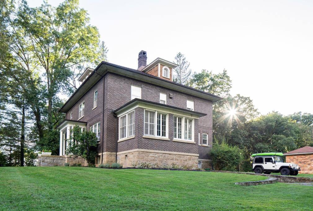 a large house with a truck parked in front of it at The Manor at Glen Jean Meadows 