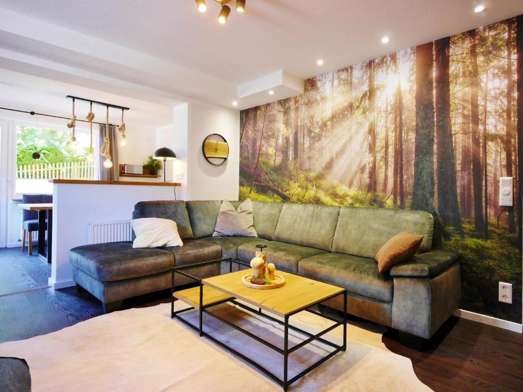 a living room with a couch and a table at Upland Apartments - Fewo Waldgeist (inkl. MeineCardPlus) in Willingen