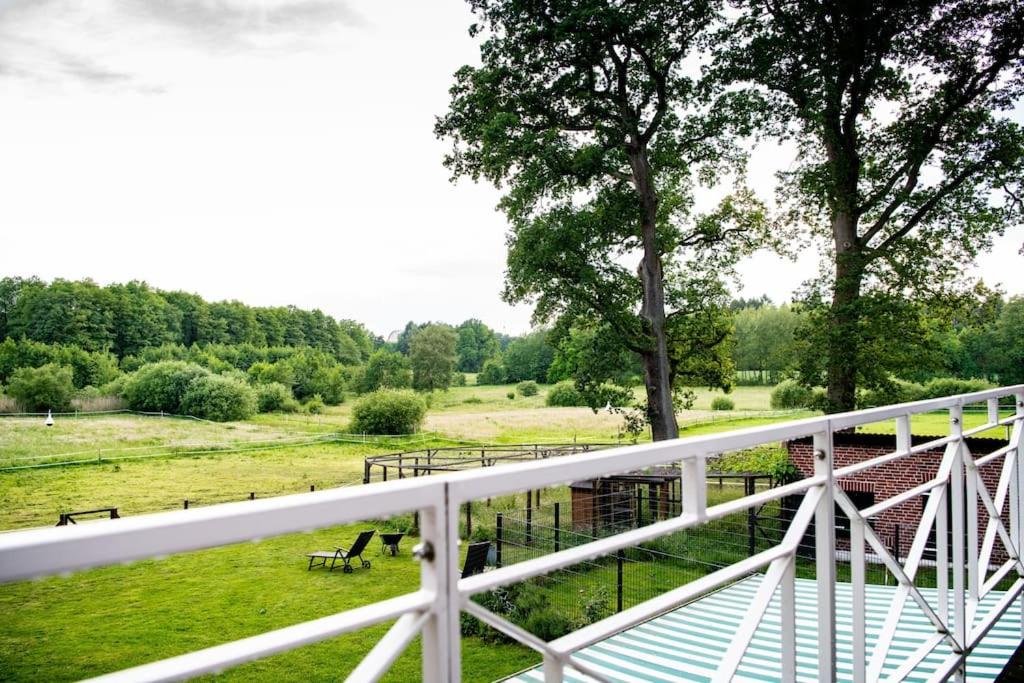 a view of a field with benches and a fence at Traumferienwohnung in der Lüneburger Heide in Soltau