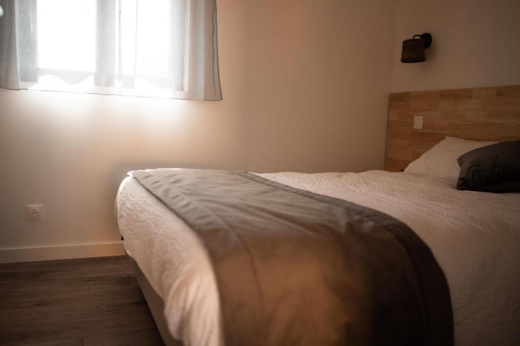 Postel nebo postele na pokoji v ubytování Les Cottages de Ripaille