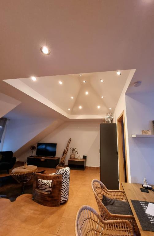 a living room with a couch and a table and chairs at Sternenhimmel-AW in Bad Neuenahr-Ahrweiler