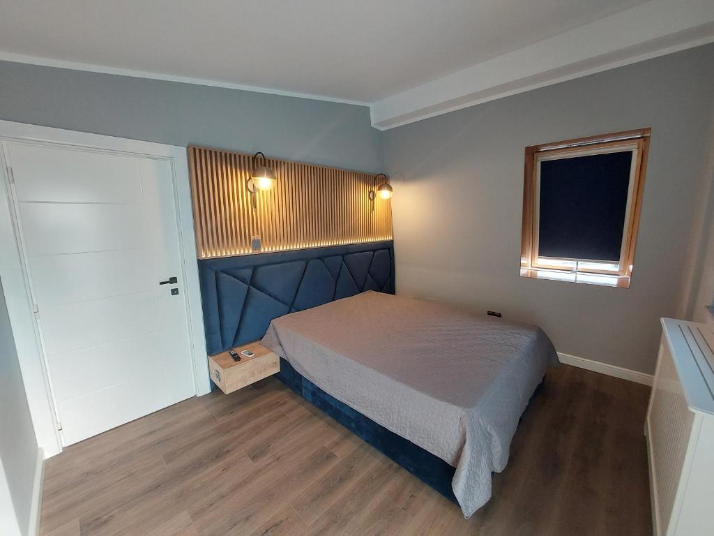 Habitación pequeña con cama y ventana en Lovely Apartment Ioana, en Tîrgu Neamţ