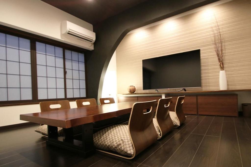 a conference room with a table and chairs and a flat screen tv at Yadoya Matsumoto Honjo - Vacation STAY 13372v in Matsumoto