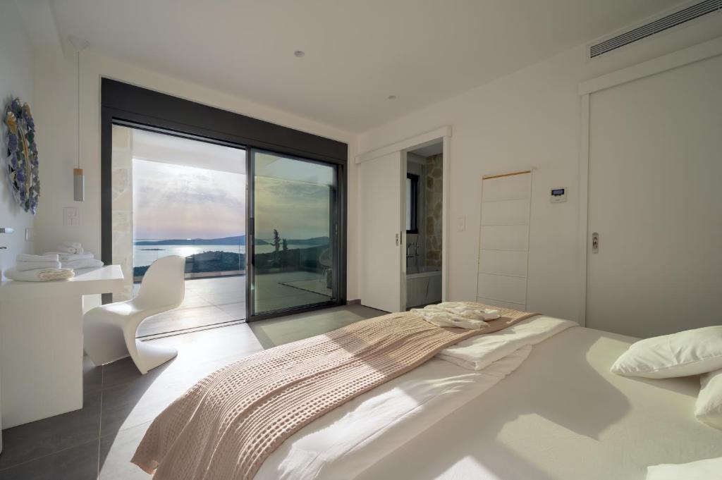 A bed or beds in a room at KOA Spa Villa-Luxury villa in Gialova with own Spa