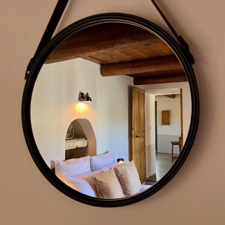 - un miroir reflétant un lit dans la chambre dans l'établissement PROCHE UZES LE COCON DU PEINTRE ANGLAIS, à Sanilhac-et-Sagriès